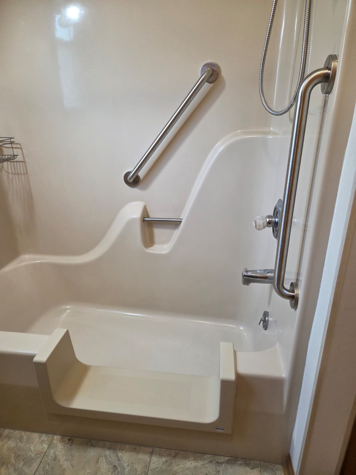 Brushed stainless steel grab bars installed for bathing safety